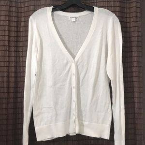 White sweater with buttons.